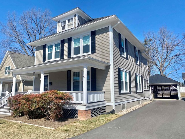 view of front of house featuring a carport and a porch