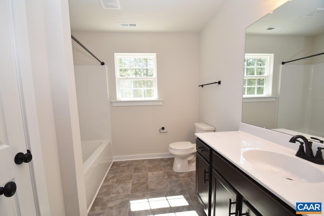 bathroom featuring a healthy amount of sunlight, toilet, and vanity