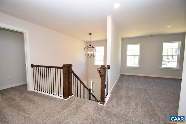 stairway with baseboards, carpet floors, recessed lighting, and an inviting chandelier