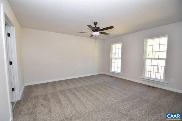 carpeted spare room with ceiling fan