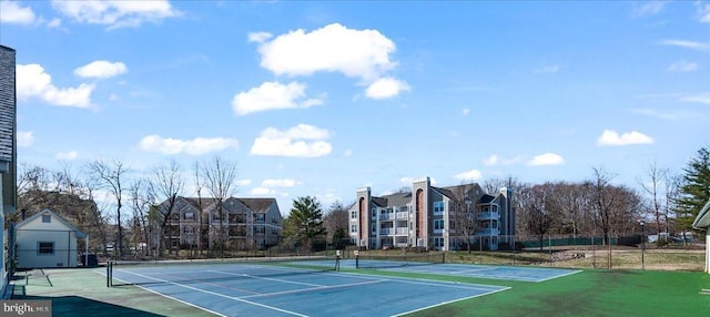 view of tennis court with fence