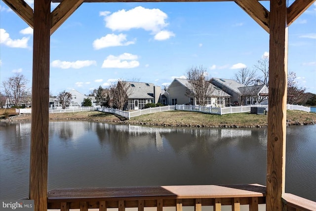 property view of water featuring fence and a residential view
