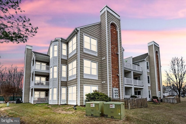 property at dusk featuring central air condition unit