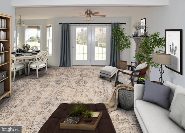 living room featuring ceiling fan with notable chandelier