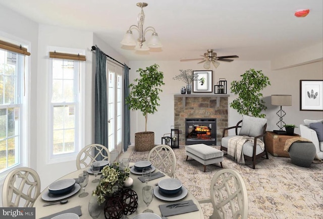 living room featuring ceiling fan with notable chandelier