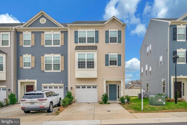 multi unit property featuring a garage and central AC