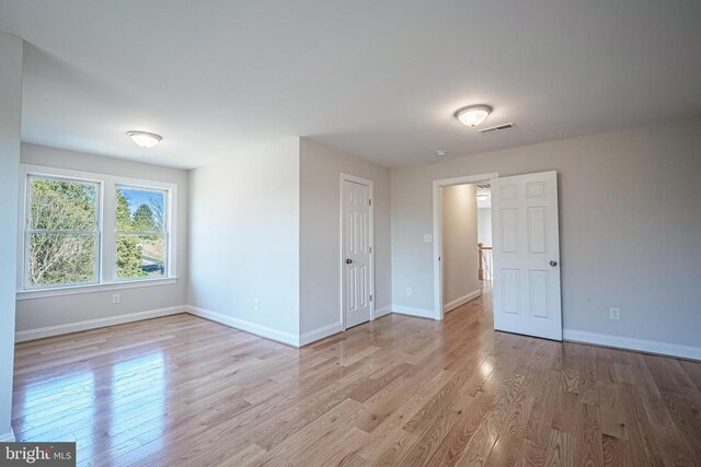 unfurnished room with light hardwood / wood-style flooring