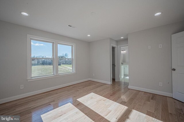 spare room featuring light hardwood / wood-style floors