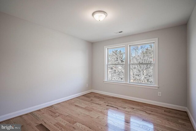 unfurnished room with light wood-type flooring