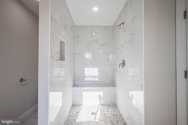 bathroom with tiled shower