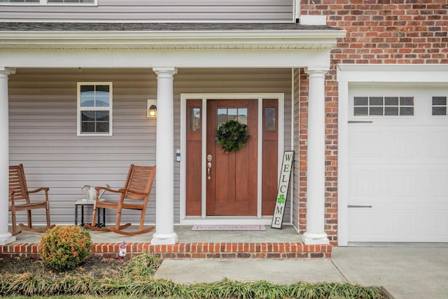 entrance to property with a porch and an attached garage