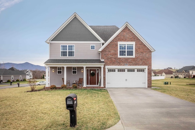 view of front of house with an attached garage, covered porch, concrete driveway, a front lawn, and a mountain view