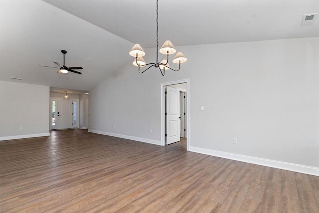 empty room featuring lofted ceiling, baseboards, visible vents, ceiling fan with notable chandelier, and wood finished floors