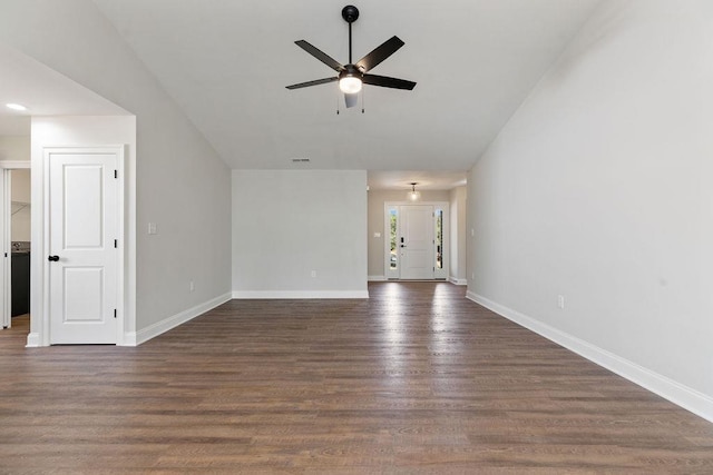 unfurnished living room with dark wood-style floors, vaulted ceiling, baseboards, and a ceiling fan