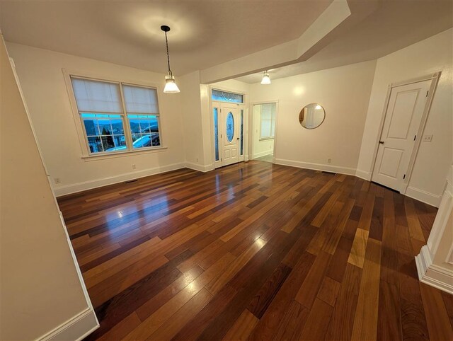 unfurnished dining area featuring dark wood-type flooring