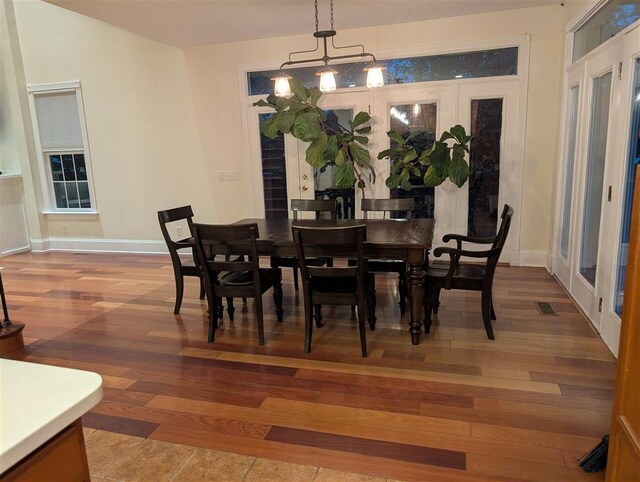 dining room featuring hardwood / wood-style flooring and french doors