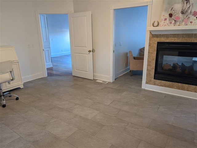 unfurnished living room with a tile fireplace