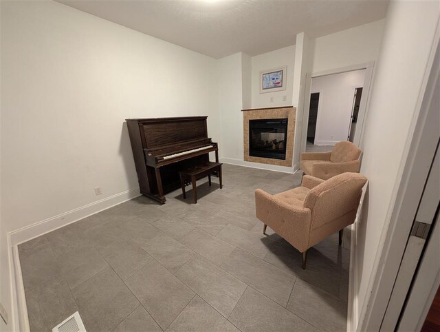 living area with a tile fireplace