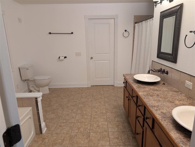 bathroom with tasteful backsplash, vanity, a bath, and toilet