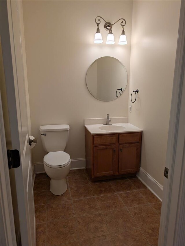 bathroom featuring vanity, tile patterned floors, and toilet