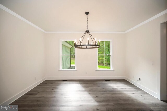 unfurnished dining area with crown molding, dark hardwood / wood-style floors, and a notable chandelier