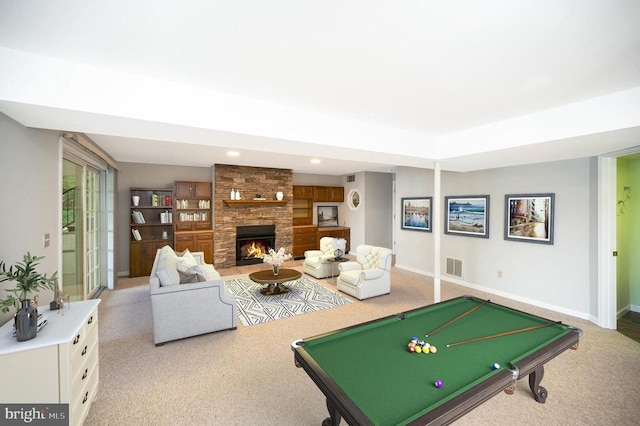 game room with light carpet, a stone fireplace, visible vents, and baseboards