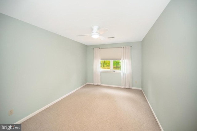 unfurnished room featuring light carpet, ceiling fan, visible vents, and baseboards