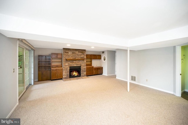 unfurnished living room featuring a fireplace, recessed lighting, visible vents, light carpet, and baseboards