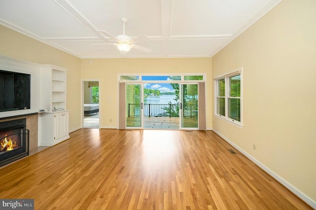 unfurnished living room with ceiling fan, a fireplace, coffered ceiling, baseboards, and light wood-style floors