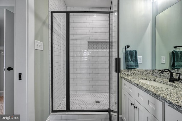 bathroom featuring vanity and a shower stall