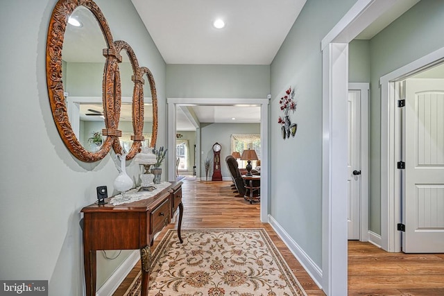 corridor with recessed lighting, baseboards, and wood finished floors