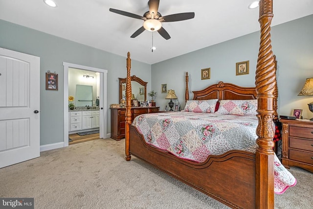 carpeted bedroom featuring recessed lighting, baseboards, ensuite bath, and ceiling fan