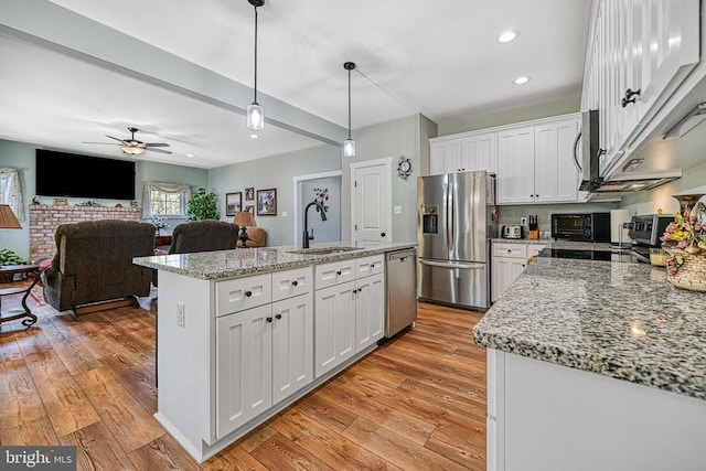 kitchen with white cabinetry, light wood-style flooring, appliances with stainless steel finishes, and a sink