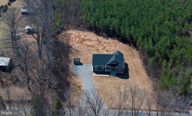 bird's eye view featuring a wooded view