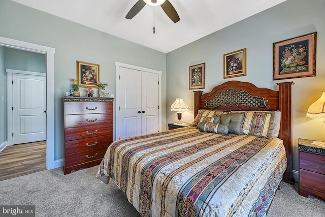 carpeted bedroom with a closet, baseboards, and ceiling fan