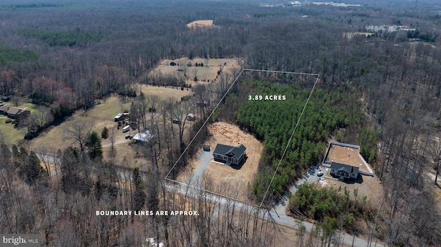 birds eye view of property with a forest view