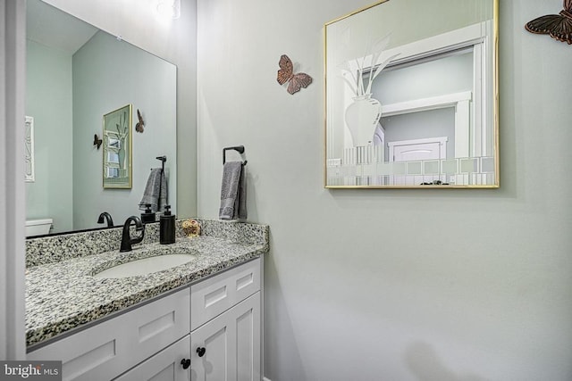 half bath featuring toilet and vanity