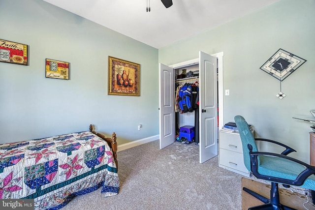 carpeted bedroom with a closet, baseboards, and ceiling fan