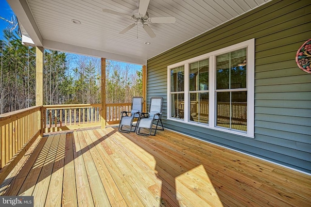 wooden deck featuring a ceiling fan