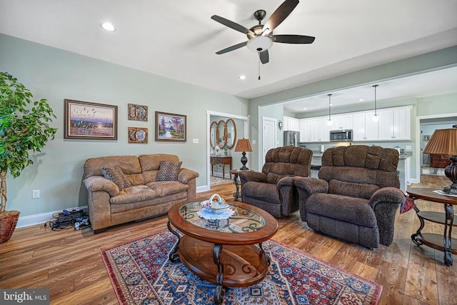 living area with hardwood / wood-style floors, recessed lighting, baseboards, and ceiling fan