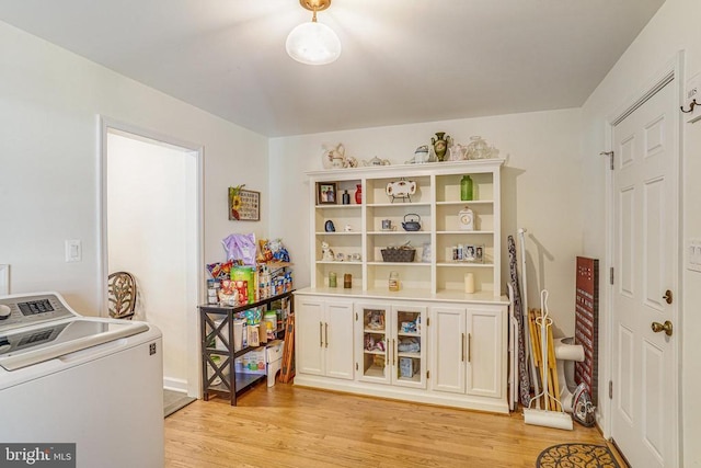 playroom with washer / clothes dryer and light wood-style floors