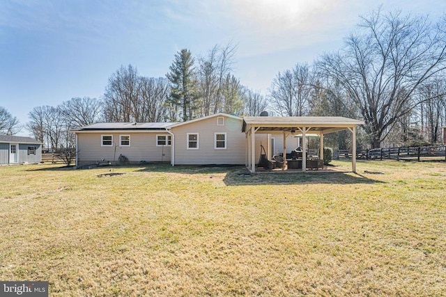 rear view of house featuring a lawn, a patio area, and fence