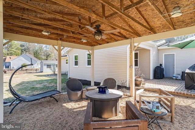 view of patio / terrace with a ceiling fan and an outdoor structure