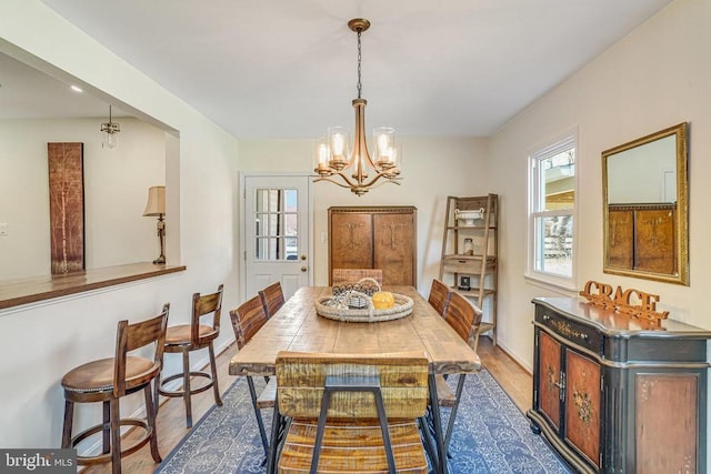 dining room with a chandelier and wood finished floors