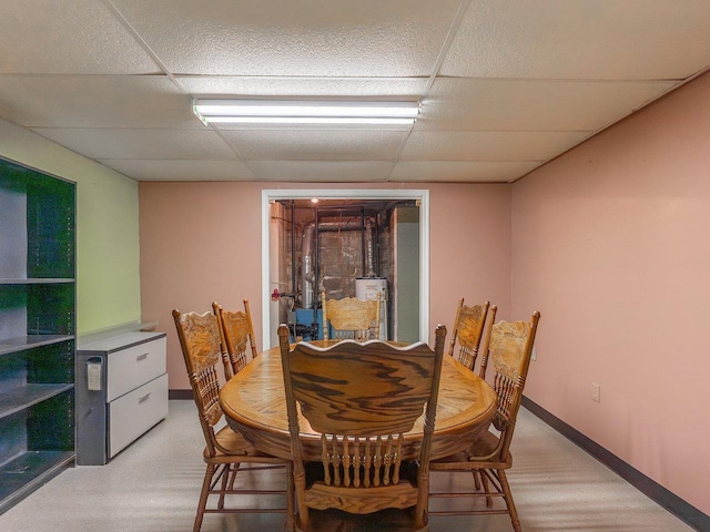 dining area featuring a drop ceiling