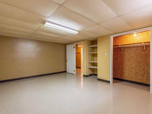 unfurnished bedroom with a closet and a drop ceiling