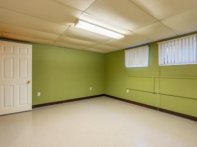 basement with a paneled ceiling