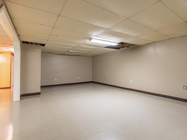 basement featuring a paneled ceiling