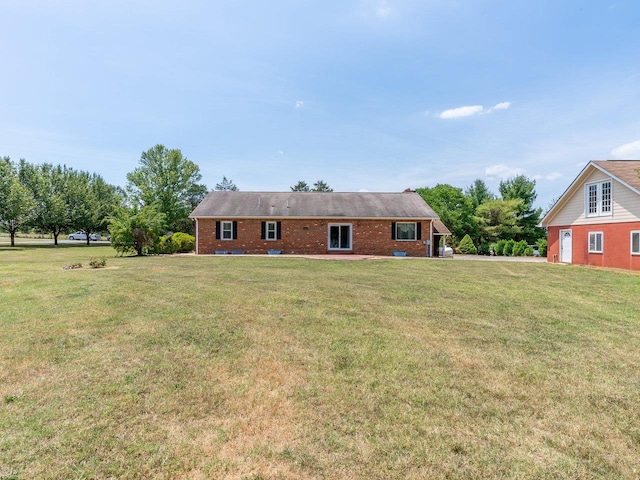 back of property with a lawn