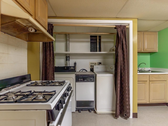 kitchen with tasteful backsplash, washer and dryer, sink, and white appliances